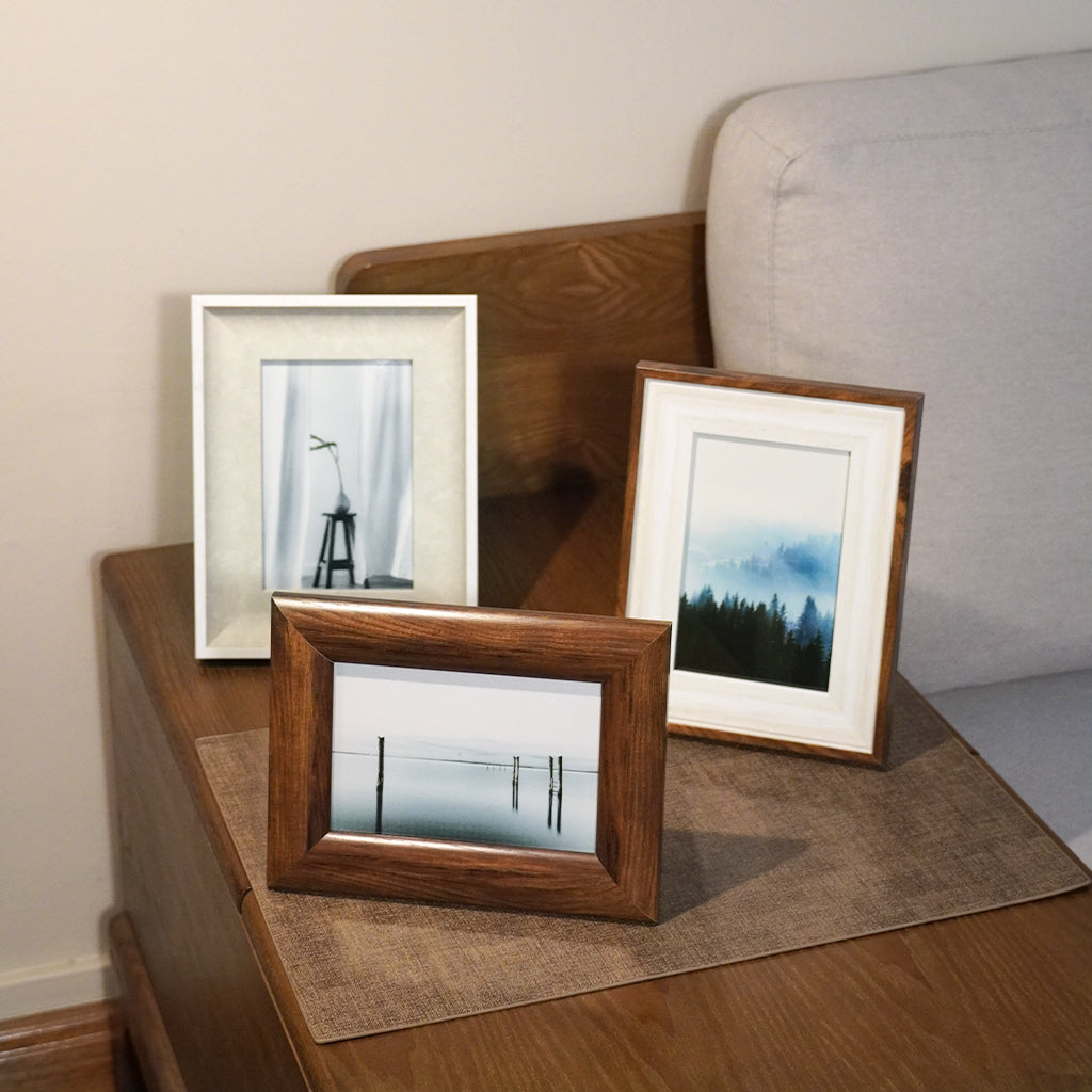 Various modern minimalistic wood mid century 4r and 5r photo frames with cherished picture on wall and can be placed on table