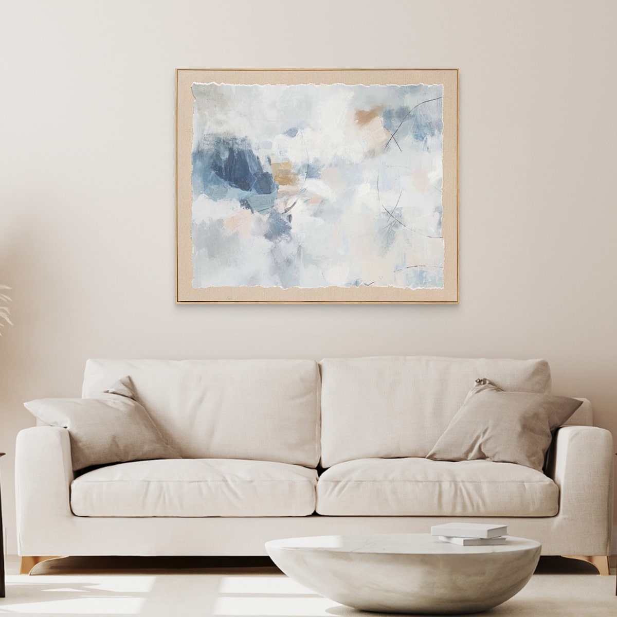 Beige sofa in a living room with Lifted Light watercolour painting above it