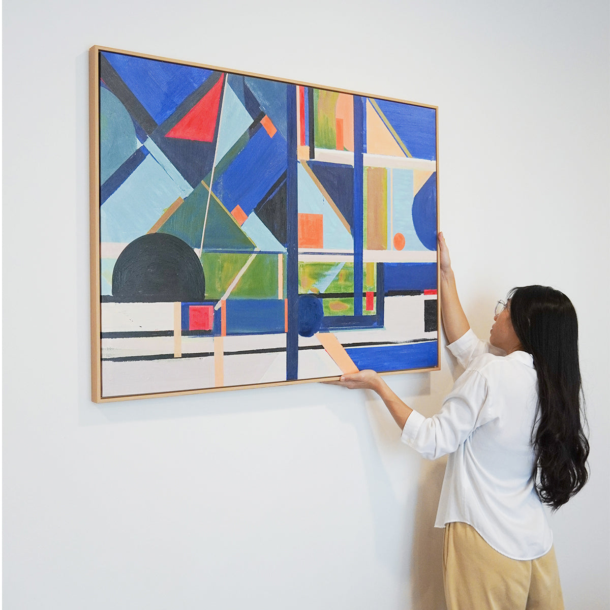 woman hanging Abstract textured wall art affordable oil painting colourful blue city landscape