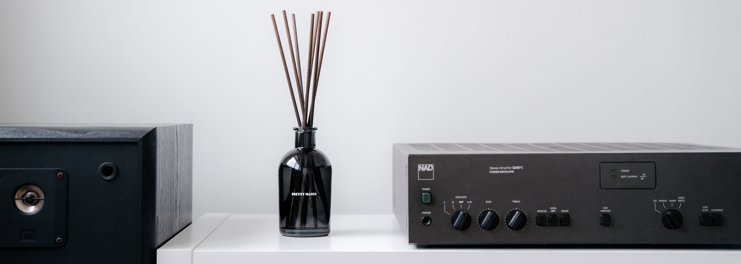 pretty major home reed diffuser bottle in listening room playing spotify playlist music